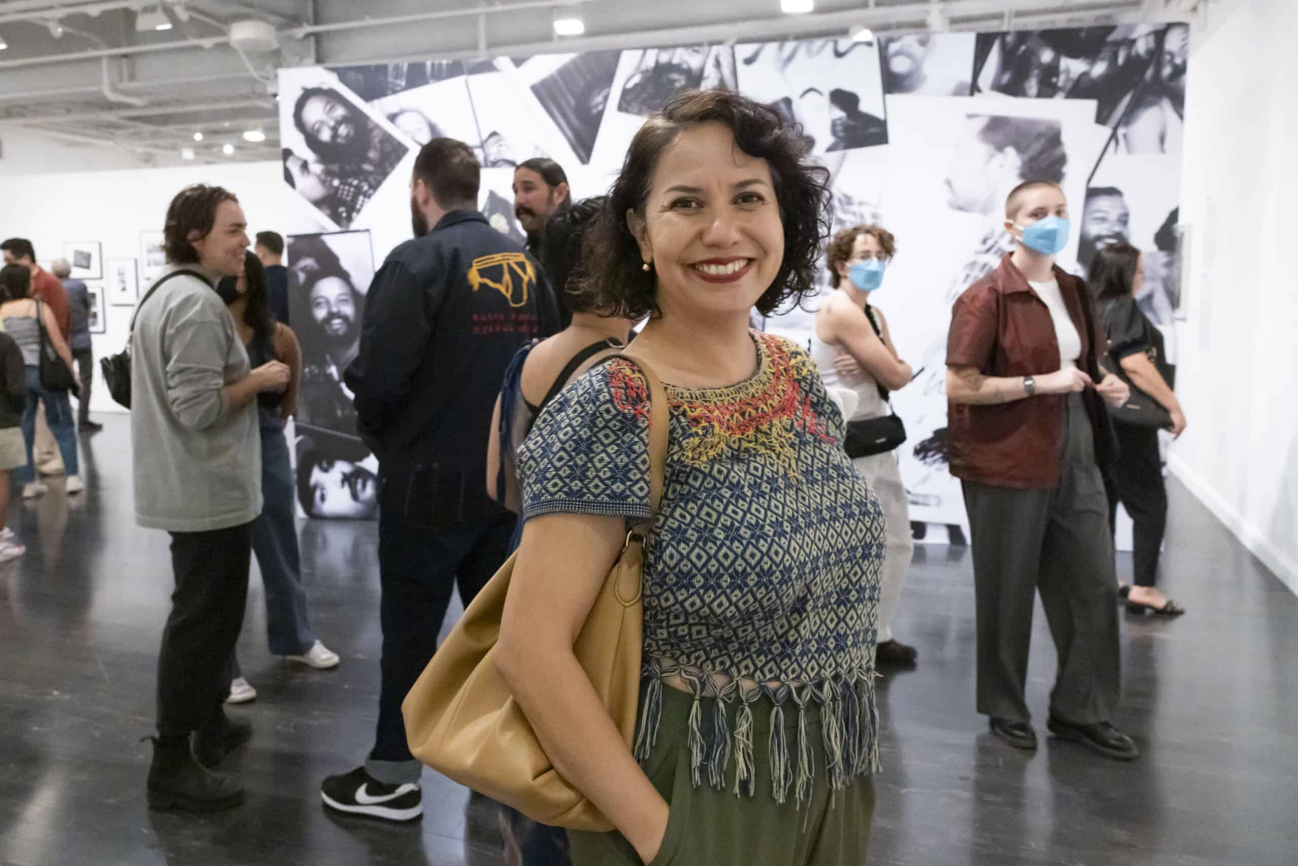 A woman standing in front of a large group of people.