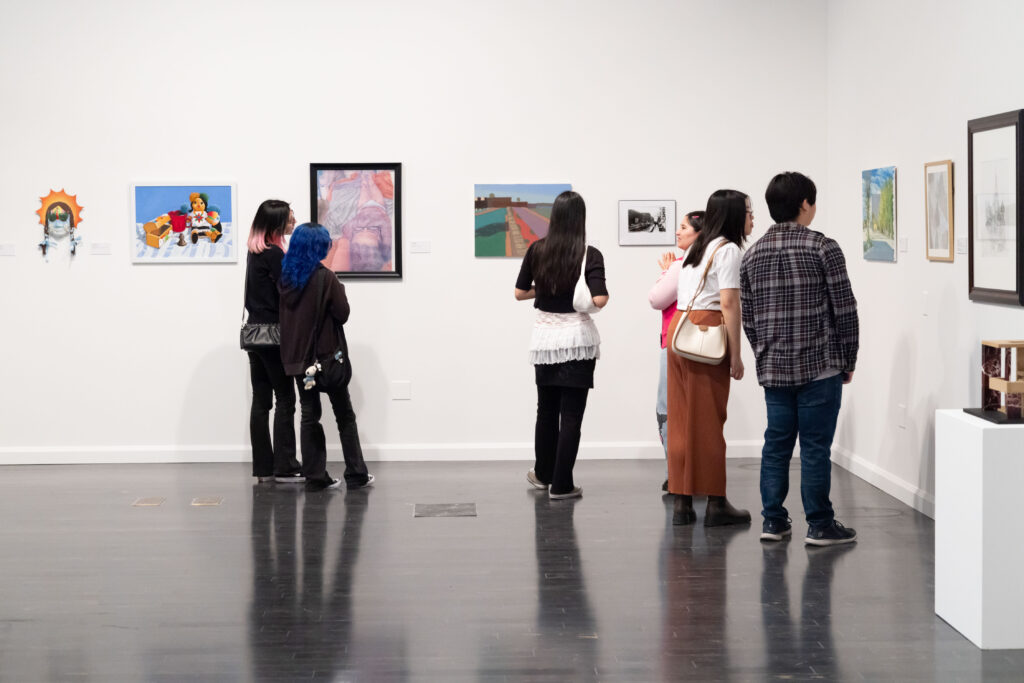 a group of people looking at art