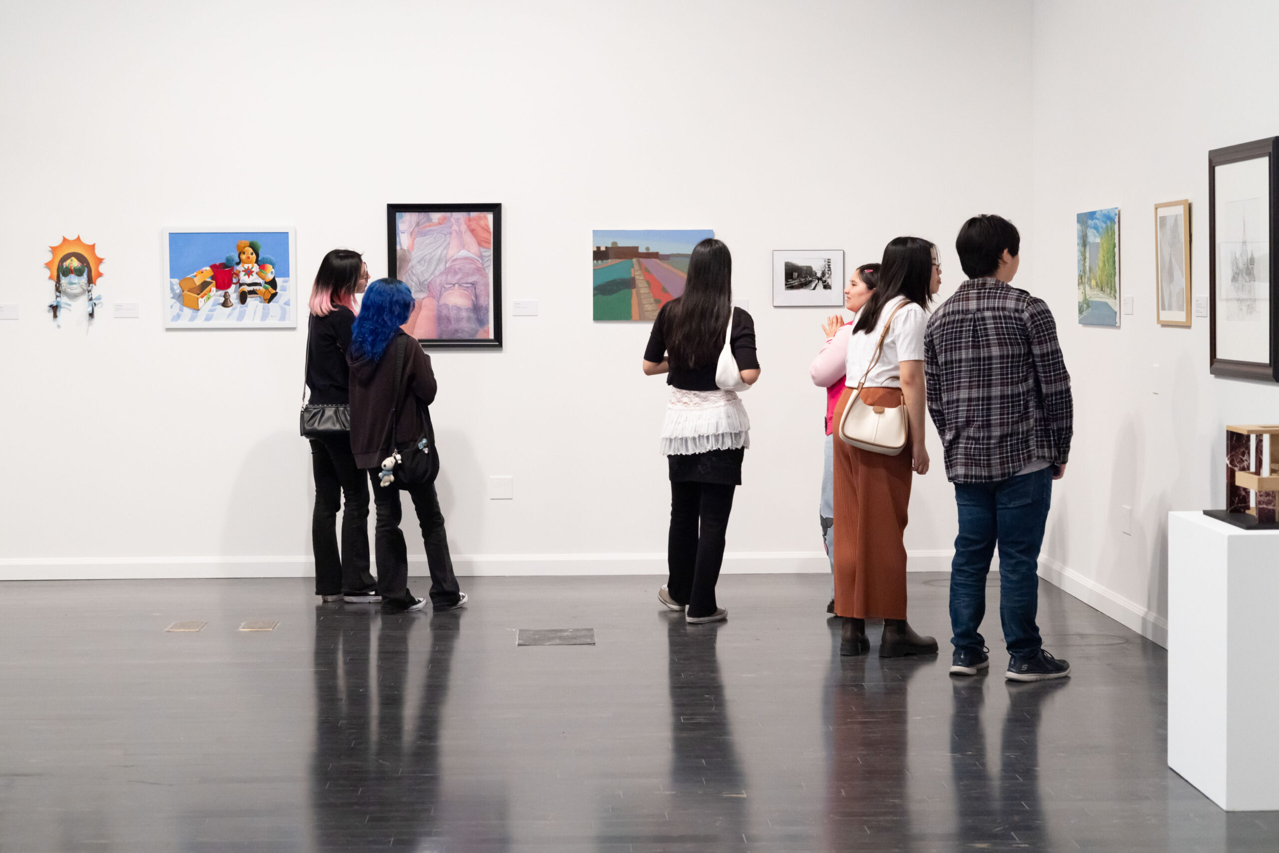 a group of people looking at art