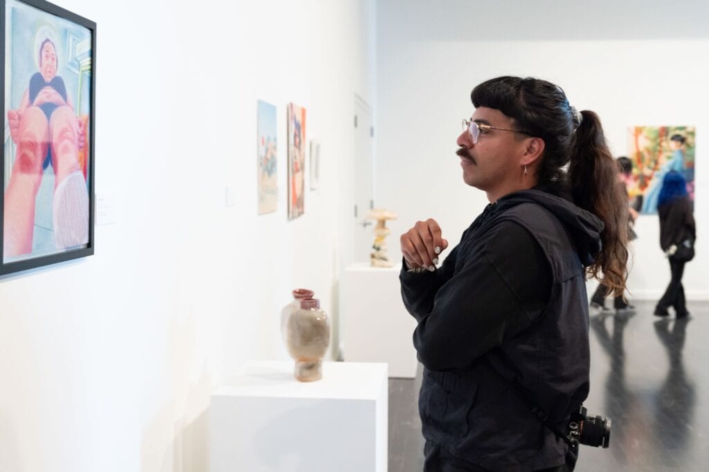 a person looking at artwork on a wall