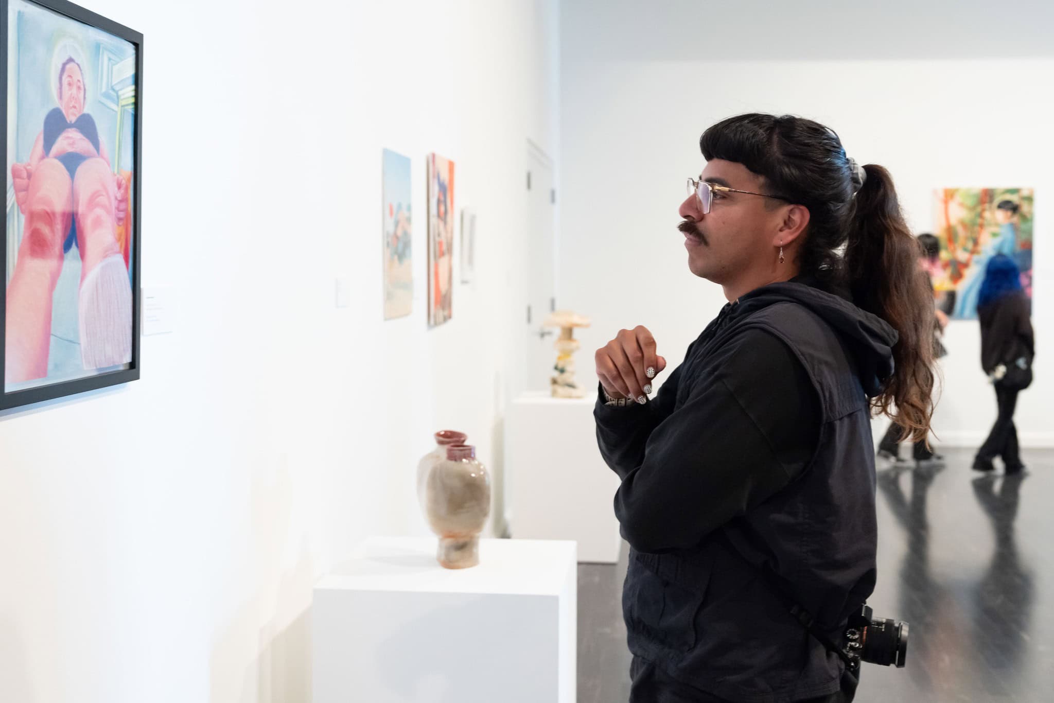 a person looking at artwork on a wall