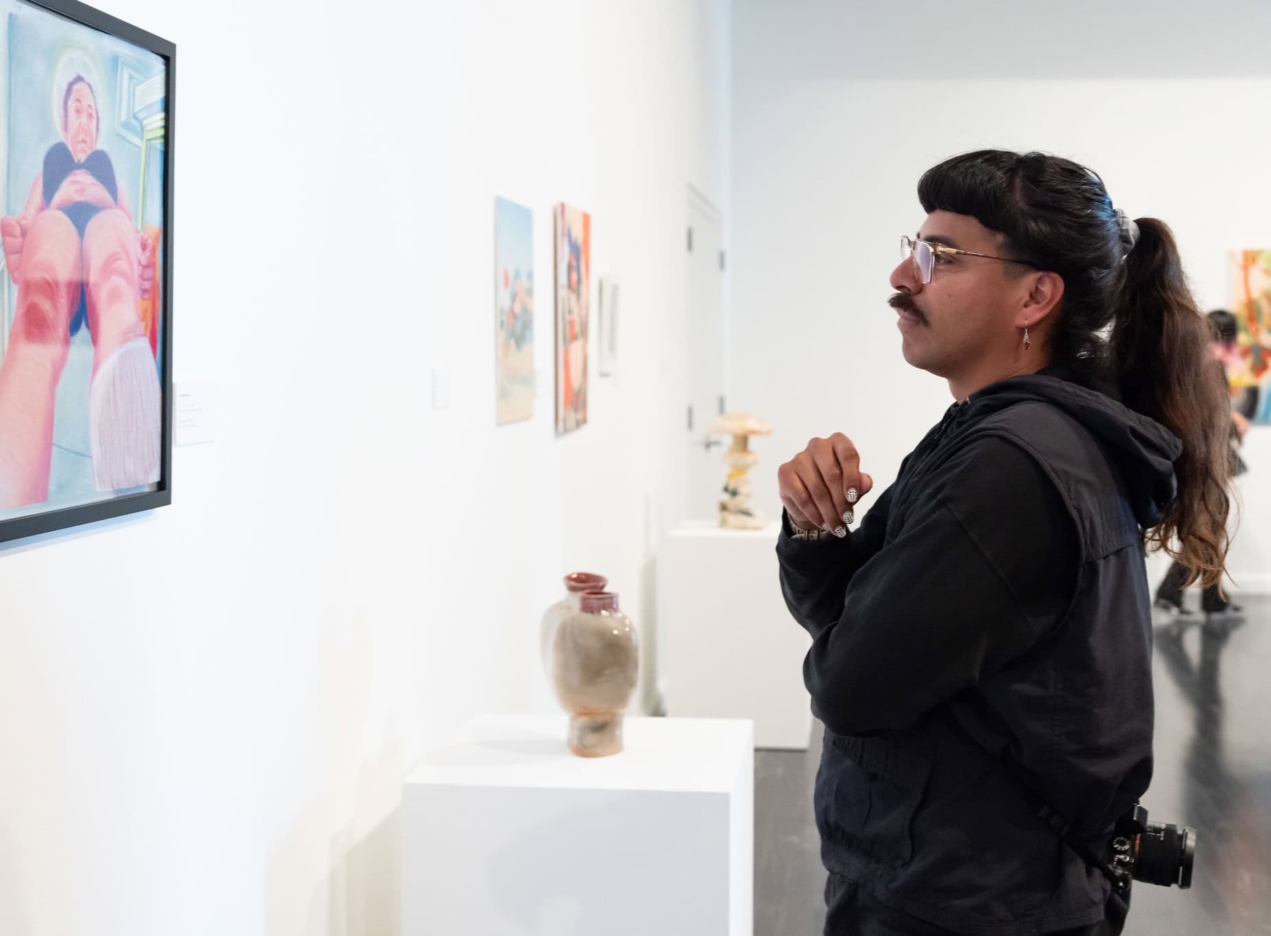 a person looking at artwork in a gallery